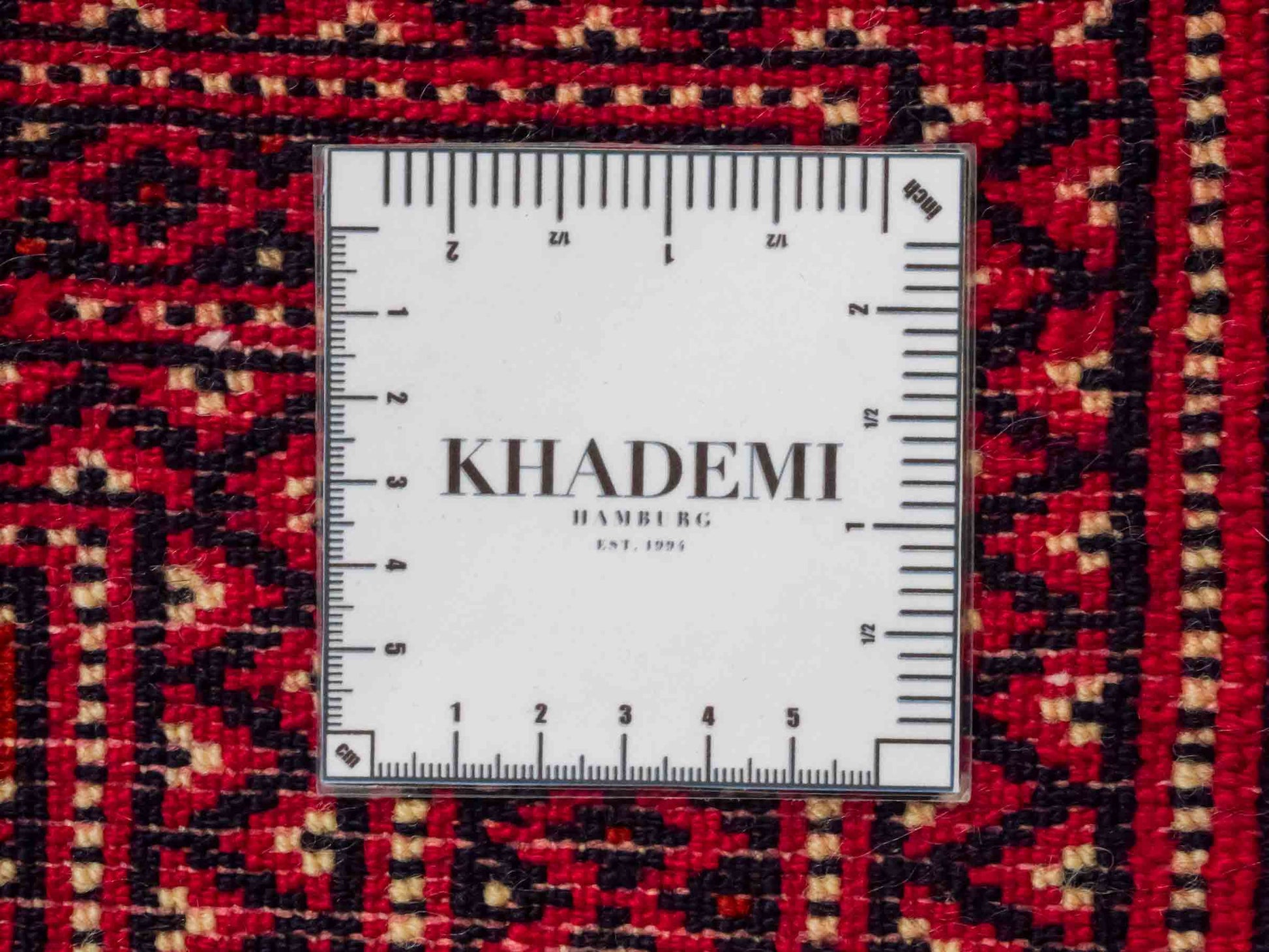Handgeknüpfter Vintage Turkaman Nomadenteppich von Khademi aus Wolle, rot. Bukhara Allover-Design. Von Hand geknüpft in Iran. Größe: 56 cm x 97 cm. Teppichnummer: DB3-1026. Verkauf durch Jupiter Intl.