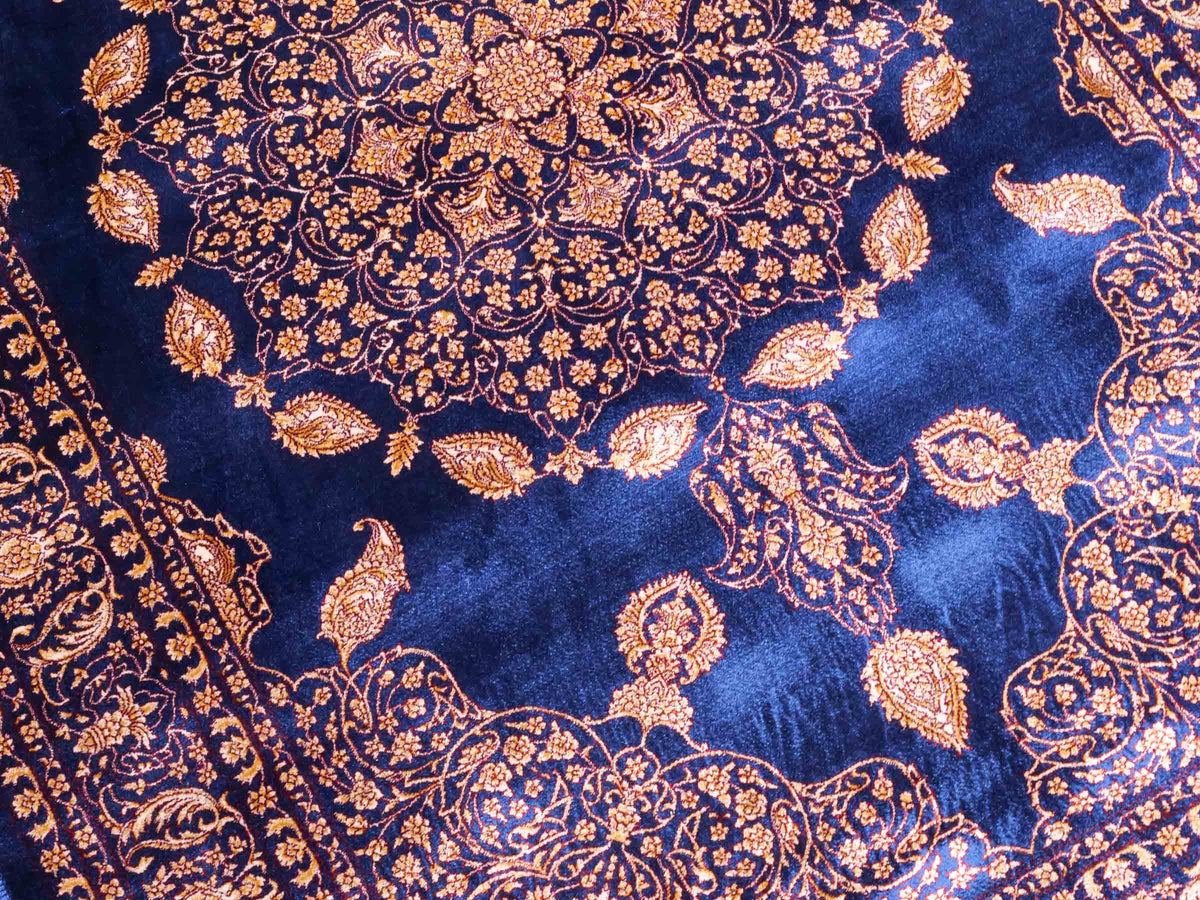 Ghom Maschinenteppich "Anahita" 120 x 80 cm aus pflanzlicher Seide (Viskose) mit Medaillon, Marineblau-Gold. Teppichnummer: V3NY096M. Persian Luxury Collection by Khademi. Made in Iran / Persia – Vertrieb durch JUPITER Intl.