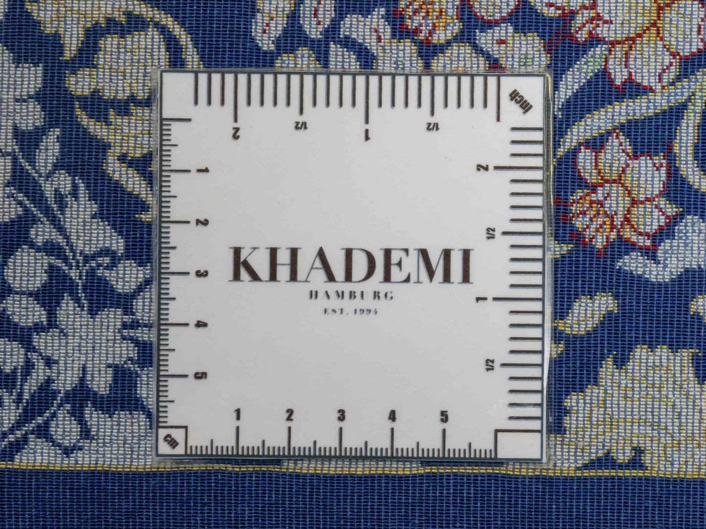 Ghom Maschinenteppich "Bahram" 35 x 35 cm aus pflanzlicher Seide (Viskose) mit floralem Bildmotiv, Marineblau. Teppichnummer: V14NY012M. Persian Luxury Collection by Khademi. Made in Iran / Persia – Vertrieb durch JUPITER Intl.
