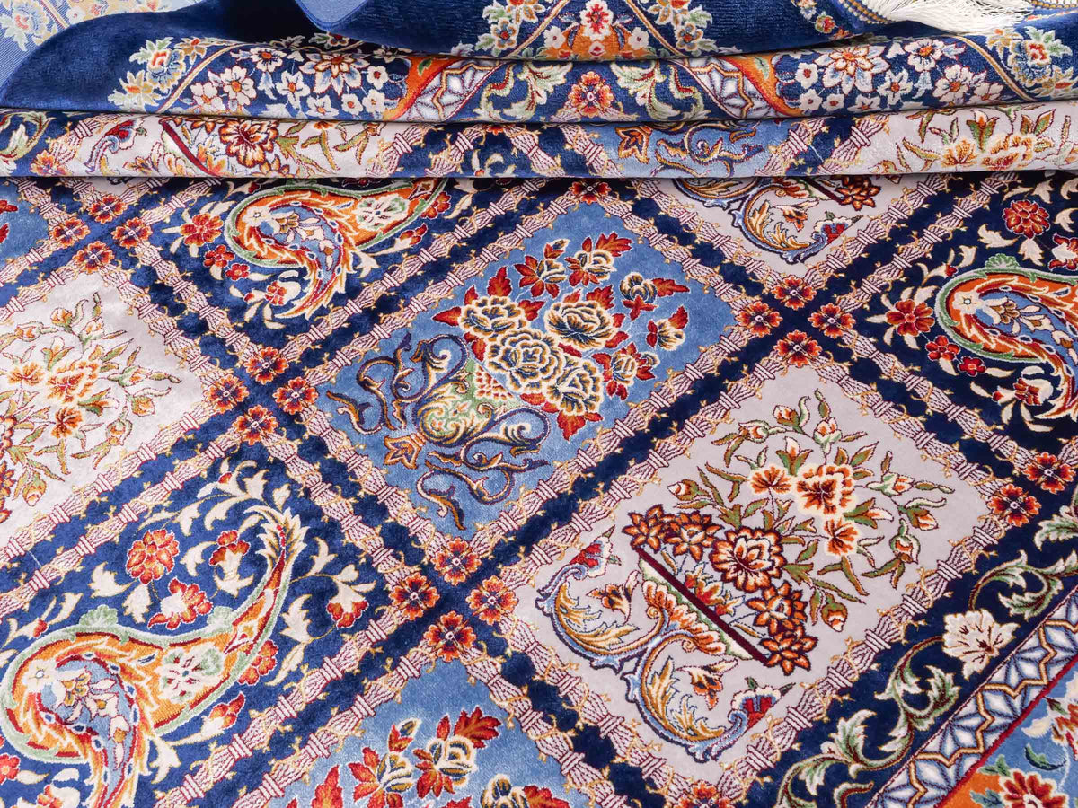 Ghom Maschinenteppich "Ferdowsi" 225 x 150 cm, mit Feldmuster, aus pflanzlicher Seide (Viskose), Marineblau/Mehrfarbig. Teppichnummer: V30NY338H. Persian Luxury Collection by Khademi. Made in Iran / Persia – Vertrieb durch JUPITER Intl.