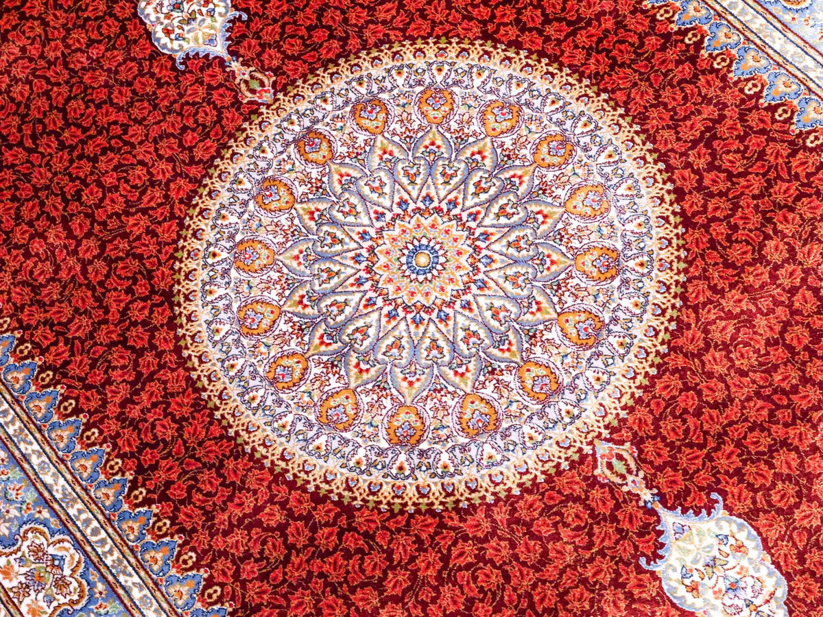 Ghom Maschinenteppich "Fereydun" 120 x 80 cm aus pflanzlicher Seide (Viskose) mit Medaillon, Rot-Orange. Teppichnummer: V28RD096M. Persian Luxury Collection by Khademi. Made in Iran / Persia – Vertrieb durch JUPITER Intl.