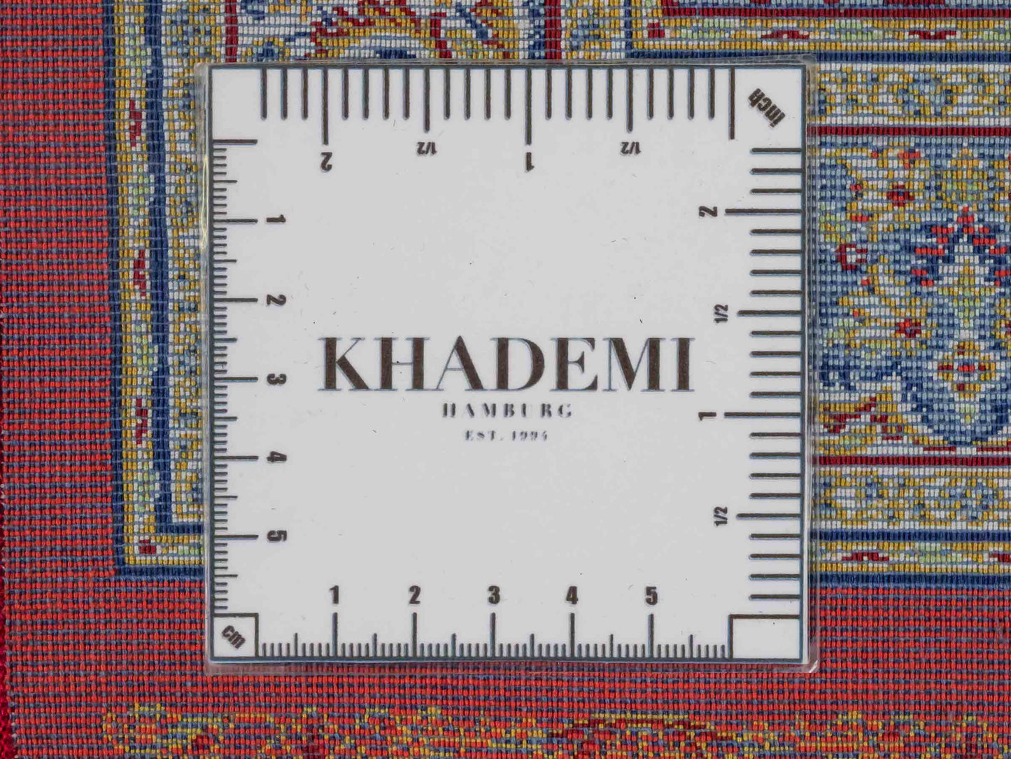 Ghom Maschinenteppich "Fereydun" 90 x 60 cm aus pflanzlicher Seide (Viskose) mit Medaillon, Orange. Teppichnummer: V28BU054M. Persian Luxury Collection by Khademi. Made in Iran / Persia – Vertrieb durch JUPITER Intl.