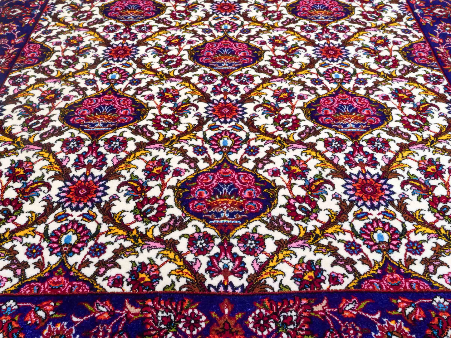 Ghom Maschinenteppich "Kiyumars" 90 x 60 cm aus pflanzlicher Seide (Viskose), Allover-Design, Cremeweiß, Blau, Rot. Teppichnummer: V53CR054M. Persian Luxury Collection by Khademi. Made in Iran / Persia – Vertrieb durch JUPITER Intl.