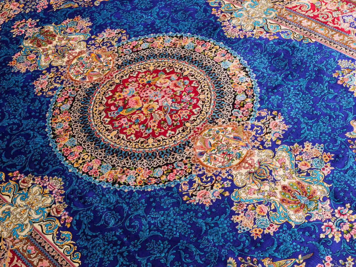Ghom Maschinenteppich "Kubad" 225 x 150 cm, mit Medaillon, aus pflanzlicher Seide (Viskose), Dunkelblau/Rot. Teppichnummer: V70DB338H. Persian Luxury Collection by Khademi. Made in Iran / Persia – Vertrieb durch JUPITER Intl.