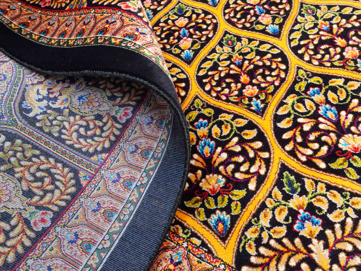 Ghom Maschinenteppich "Manuchehr" 225 x 150 cm, mit Medaillon, aus pflanzlicher Seide (Viskose), Schwarz/Gold. Teppichnummer: V56BG338H. Persian Luxury Collection by Khademi. Made in Iran / Persia – Vertrieb durch JUPITER Intl.