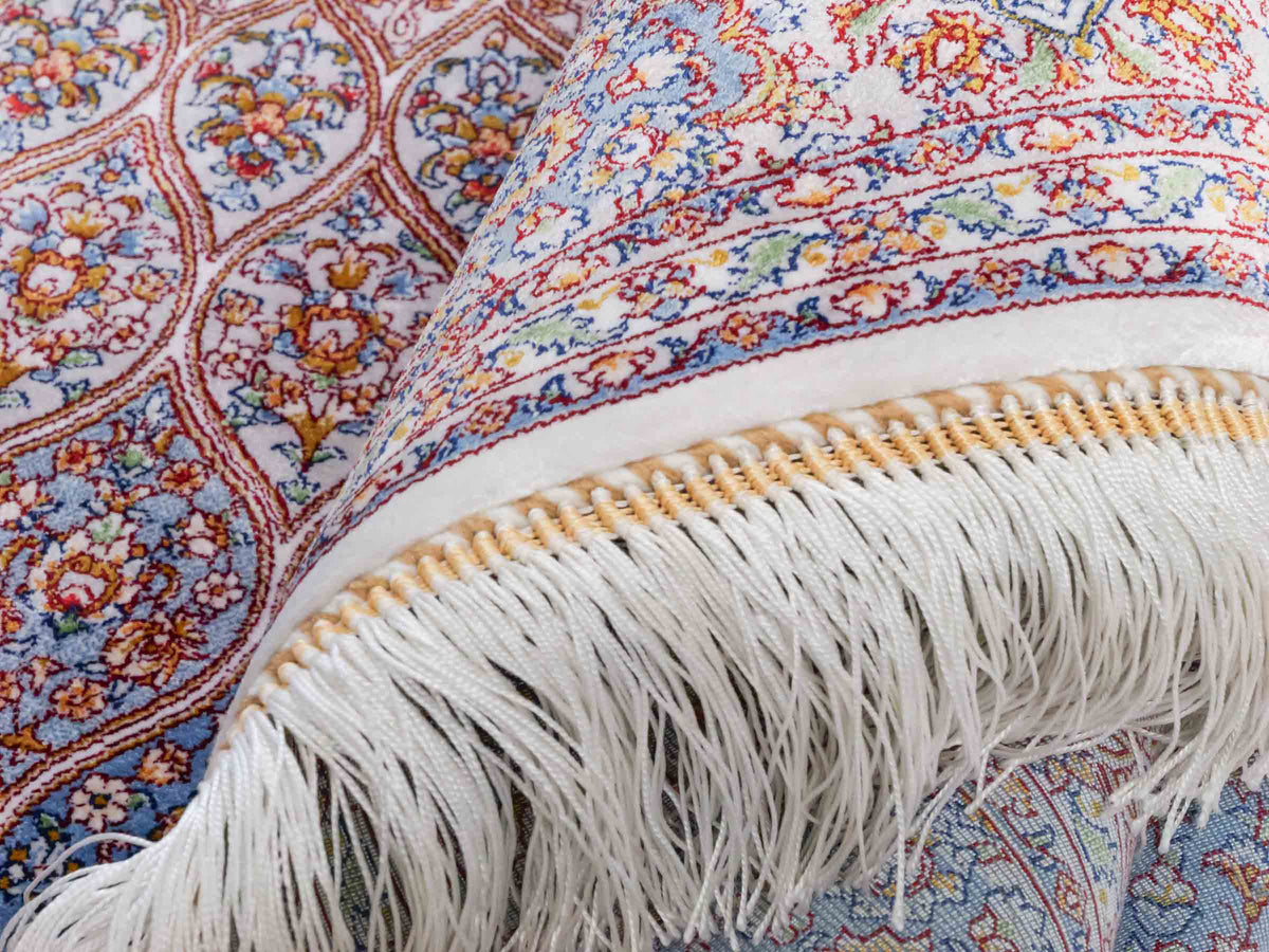 Ghom Maschinenteppich "Rudabeh" 180 x 120 cm, mit Medaillon, aus pflanzlicher Seide (Viskose), Cremeweiß-Blau. Teppichnummer: V72CR216H. Persian Luxury Collection by Khademi. Made in Iran / Persia – Vertrieb durch JUPITER Intl.