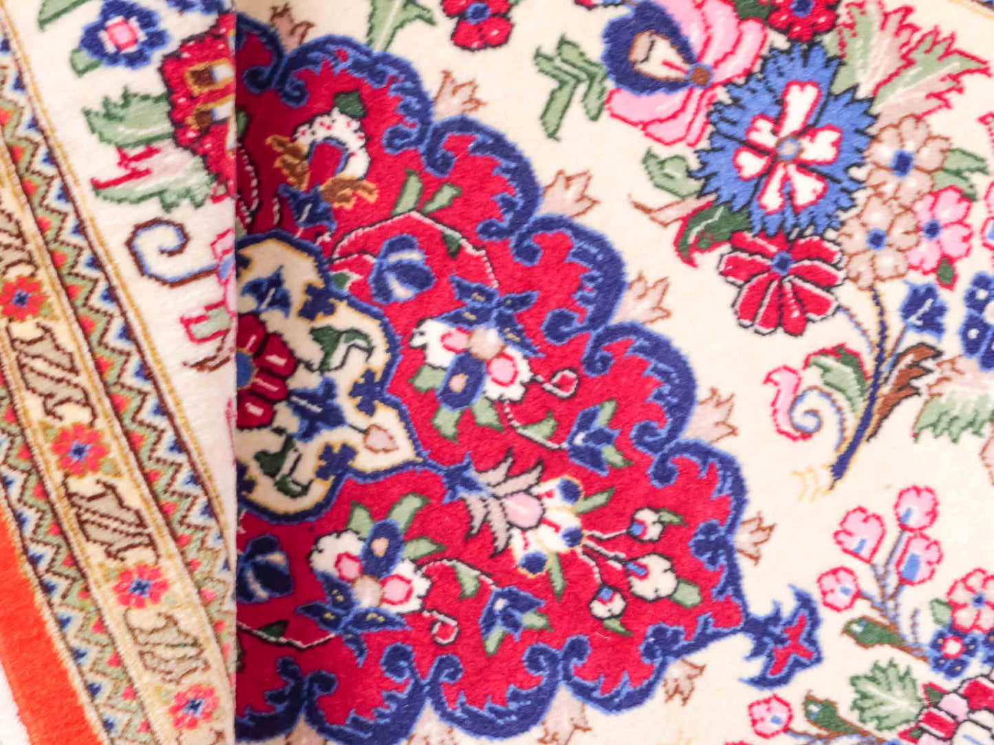 Handgeknüpfter Razawi Ghom Perserteppich von Khademi aus Wolle, cremeweiß, rot. Persischer Teppich mit Signatur. Orientteppich von Hand geknüpft in Iran. Größe: 91 cm x 65 cm. Teppichnummer: SB3-1005. Verkauf durch Jupiter Intl.
