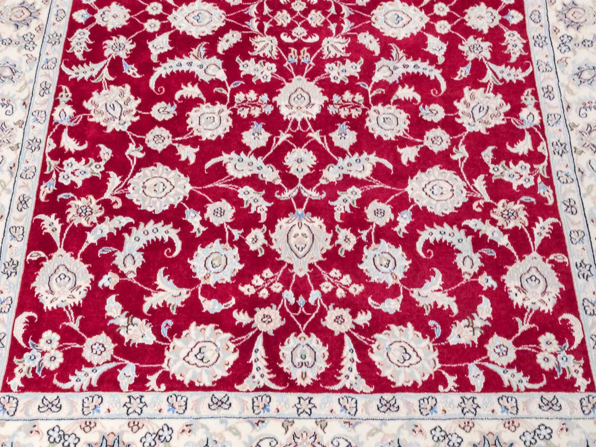Handgeknüpfter Nain 9La Perserteppich von Khademi aus Wolle mit Seide, signiert, rot-elfenbein-weiß. Persischer Orientteppich mit Allover-Motiv. Von Hand geknüpft in Iran / Persien. Größe: 205 x 136 cm. Teppichnummer: SB3-1087 | Jupiter Intl.