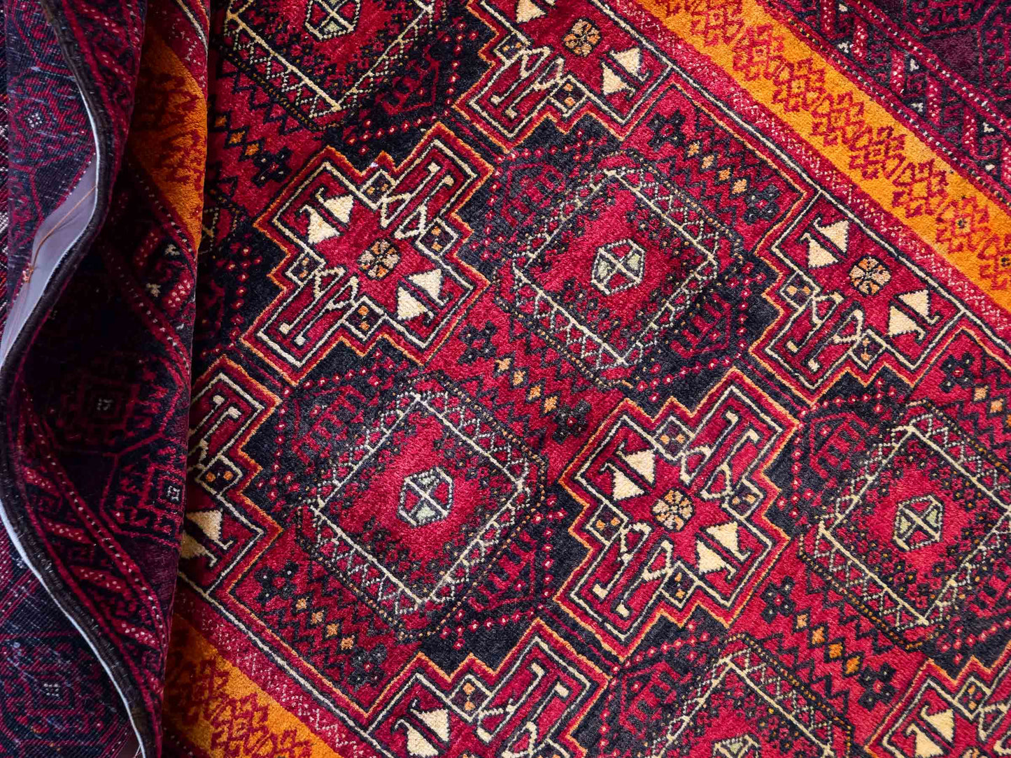 Handgeknüpfter, afghanischer, semi-antiker Belutsch Nomadenteppich aus Wolle von Khademi. Größe: 185 x 100 cm. Farbe: Rot, orange. Verkauf durch JUPITER Intl.