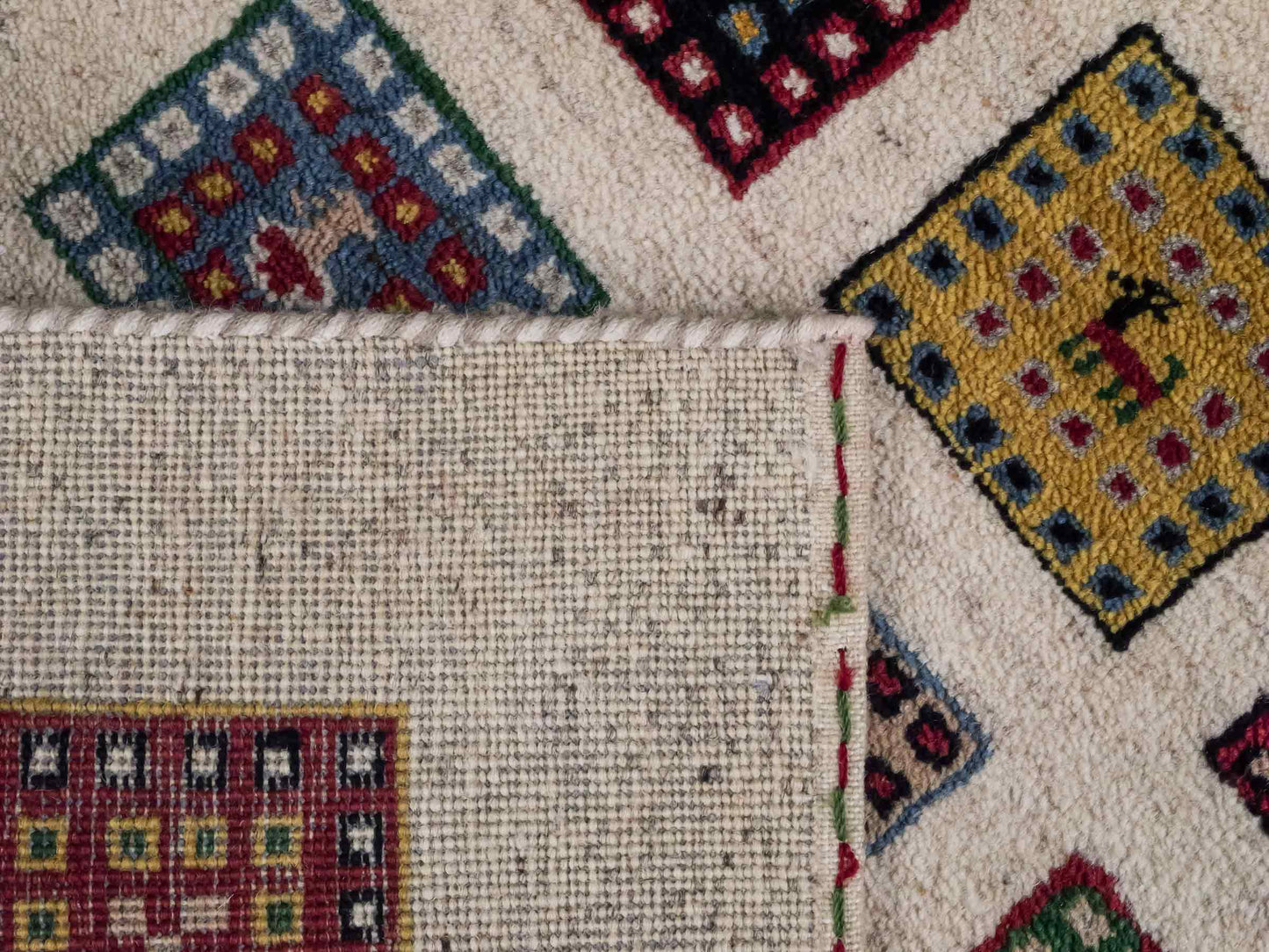 Handgeknüpfter Indo Loribaft Orientteppich von Khademi aus Wolle, cremeweiß, mehrfarbig. Geometrisches Nomaden-Feldmuster. Von Hand geknüpft in Indien. Größe: 89x59cm. Teppichnummer: KB4-1731. Verkauf durch Jupiter Intl.