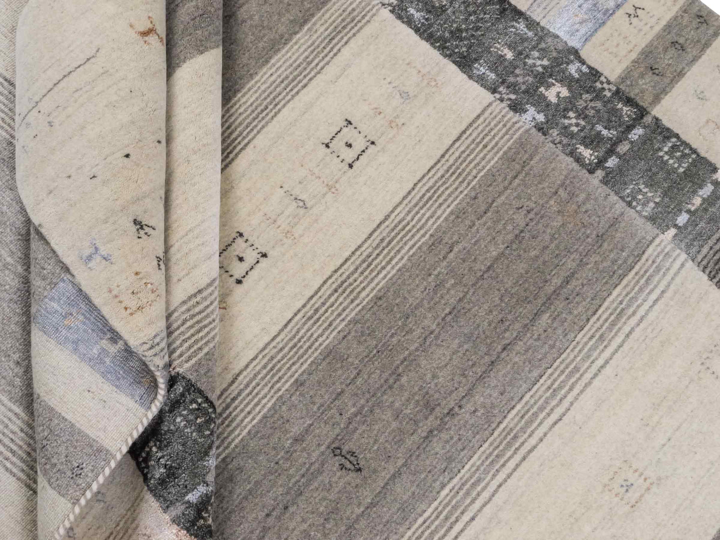 Moderner, Handloom Lori Gabbeh Orientteppich von Khademi aus Wolle mit Bambusseide, cremeweiß, grau, blau, braun. Nomaden-Design. Produziert in Indien. Größe: 241x172cm. Teppichnummer: KB4-1805. Verkauf durch Jupiter Intl.