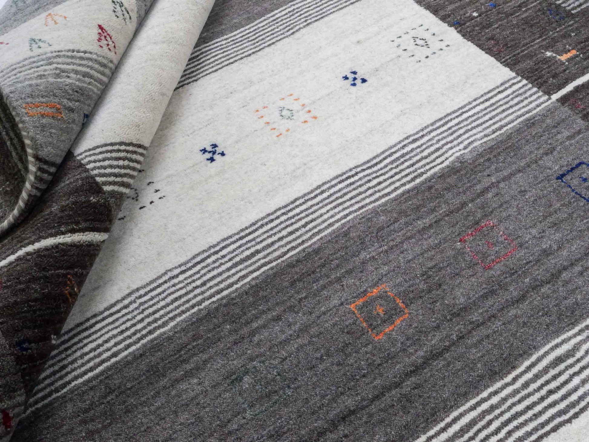 Moderner, Handloom Lori Gabbeh Orientteppich von Khademi aus Wolle mit Bambusseide, grau, mehrfarbig. Nomaden-Design. Produziert in Indien. Größe: 242x171cm. Teppichnummer: KB4-1810. Verkauf durch Jupiter Intl.