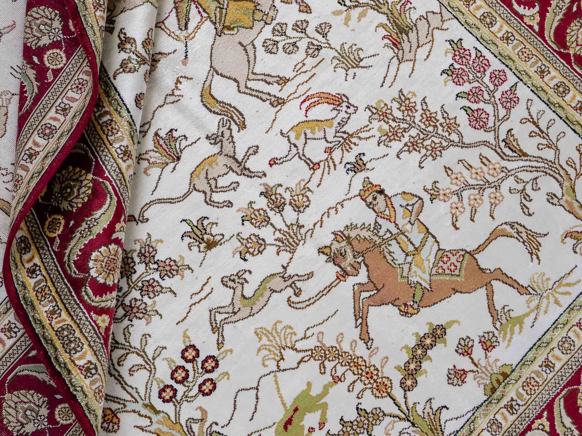 Feiner, handgeknüpfter Art Ghom aus Kunstseide. Ursprung China. Größe: 180 x 124 cm. Hauptfarben: Weiß, Creme, Rot. Vertrieb durch JUPITER Intl.