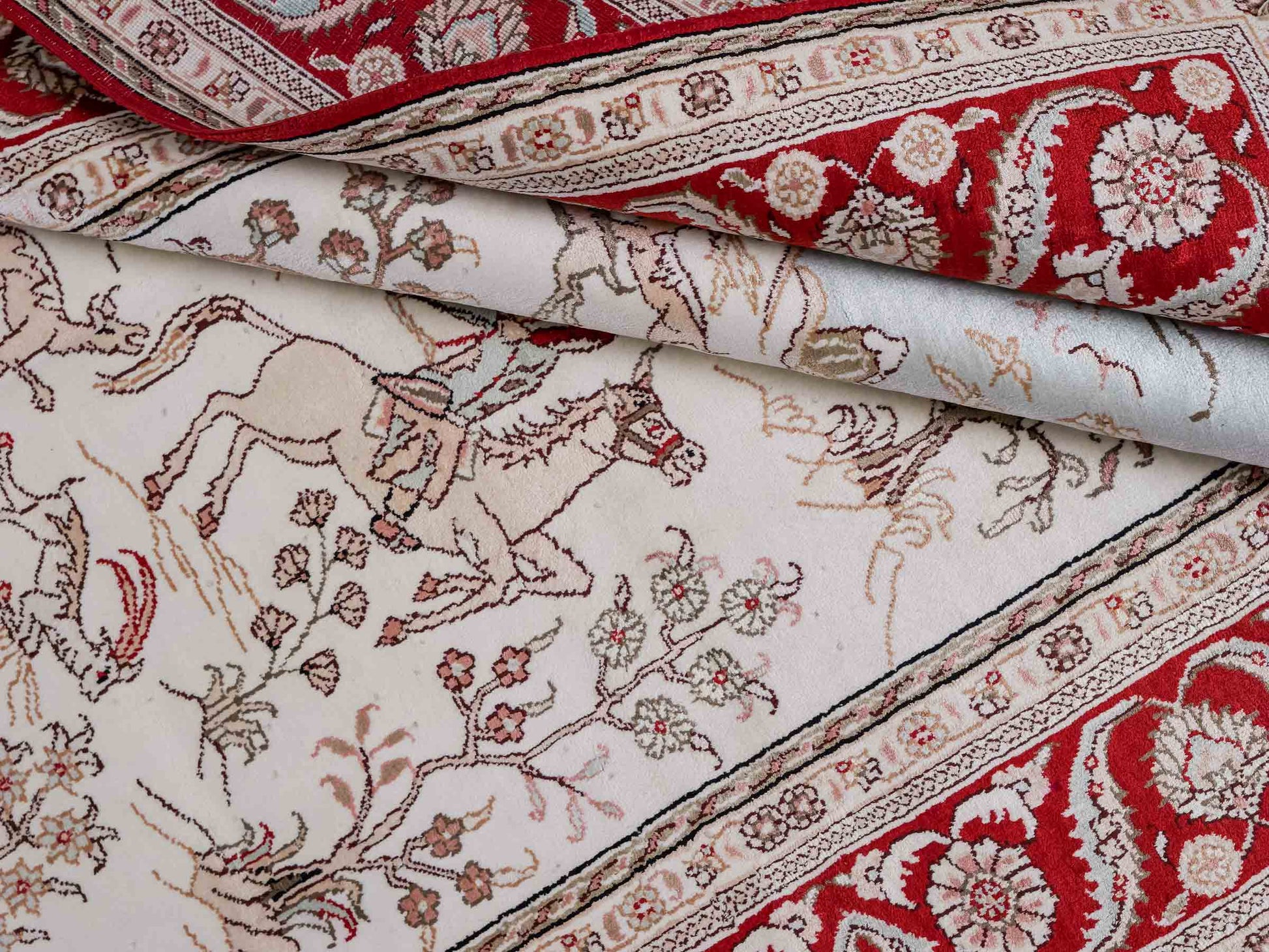 Feiner, handgeknüpfter Art Ghom aus Kunstseide. Ursprung China. Größe: 183 x 123 cm. Hauptfarben: Weiß, Creme, Rot. Vertrieb durch JUPITER Intl.