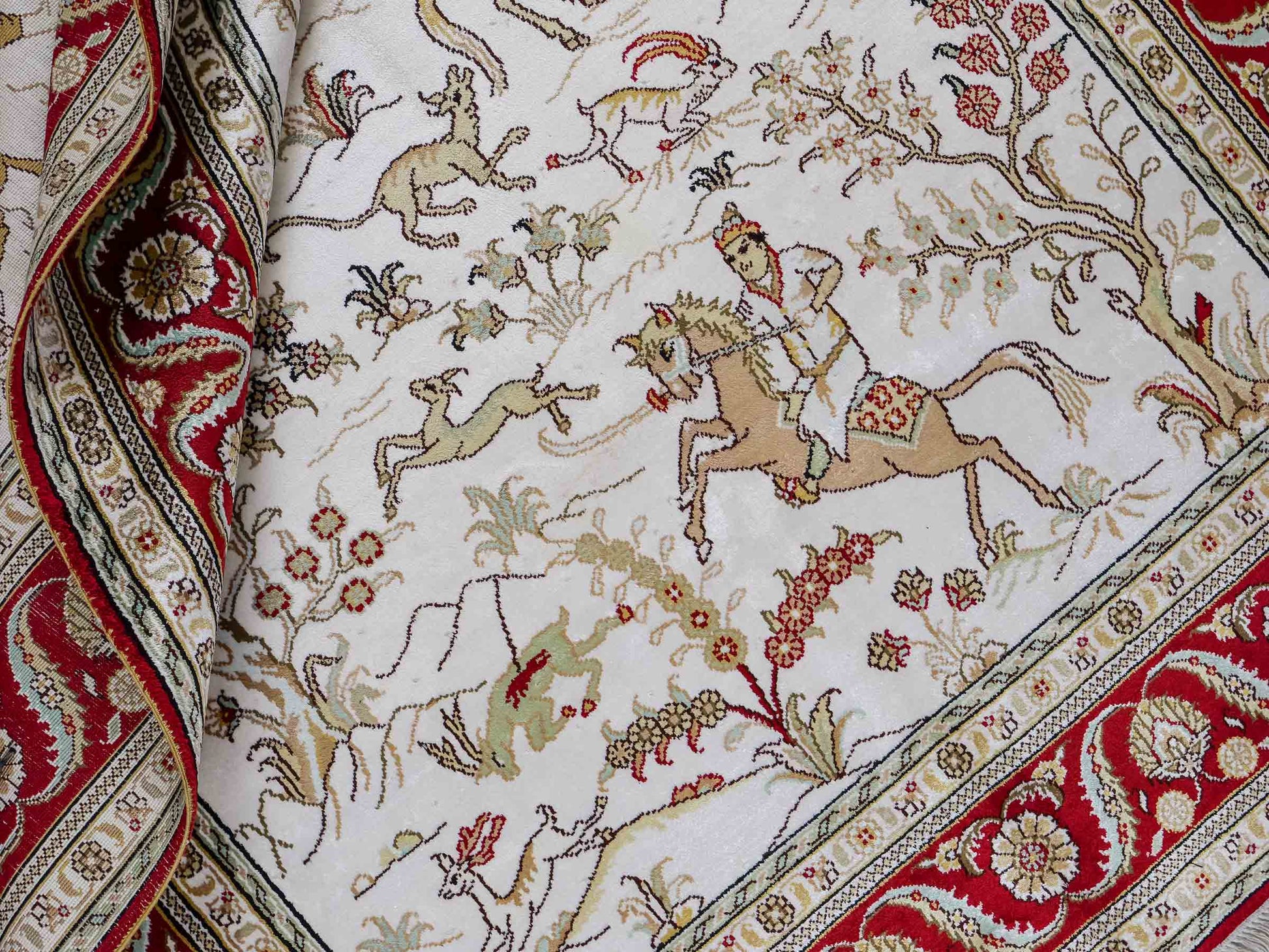 Feiner, handgeknüpfter Art Ghom aus Kunstseide. Ursprung China. Größe: 183 x 124 cm. Hauptfarben: Weiß, Creme, Rot. Vertrieb durch JUPITER Intl.