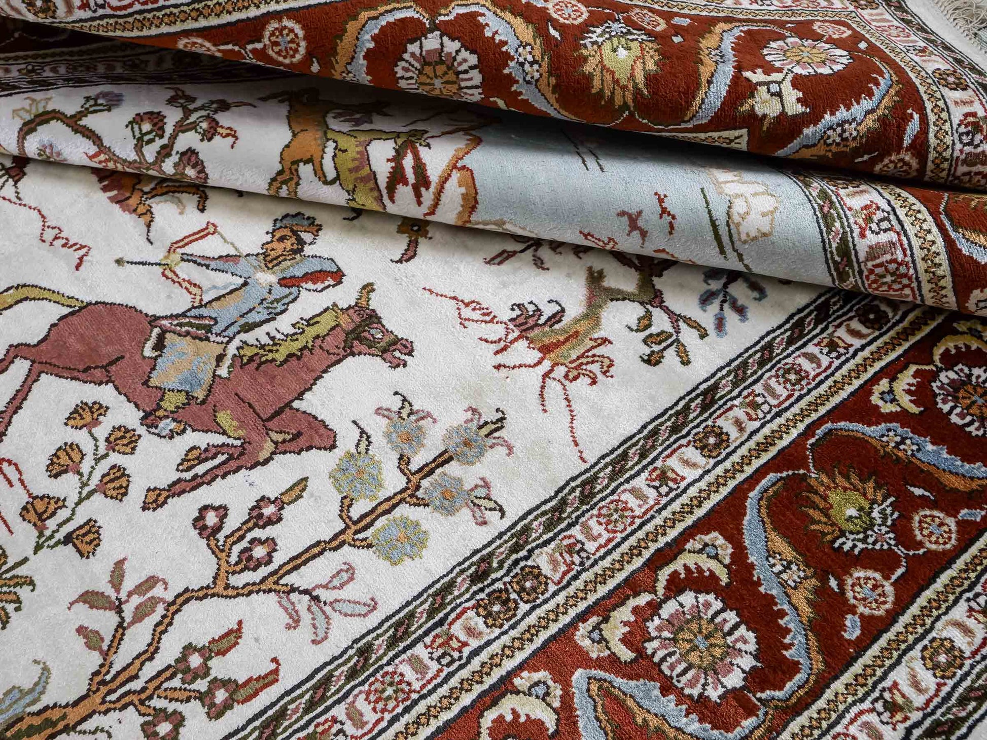 Feiner, handgeknüpfter Art Ghom aus Kunstseide. Ursprung China. Größe: 184 x 125 cm. Hauptfarben: Weiß, Creme, Rot. Vertrieb durch JUPITER Intl.