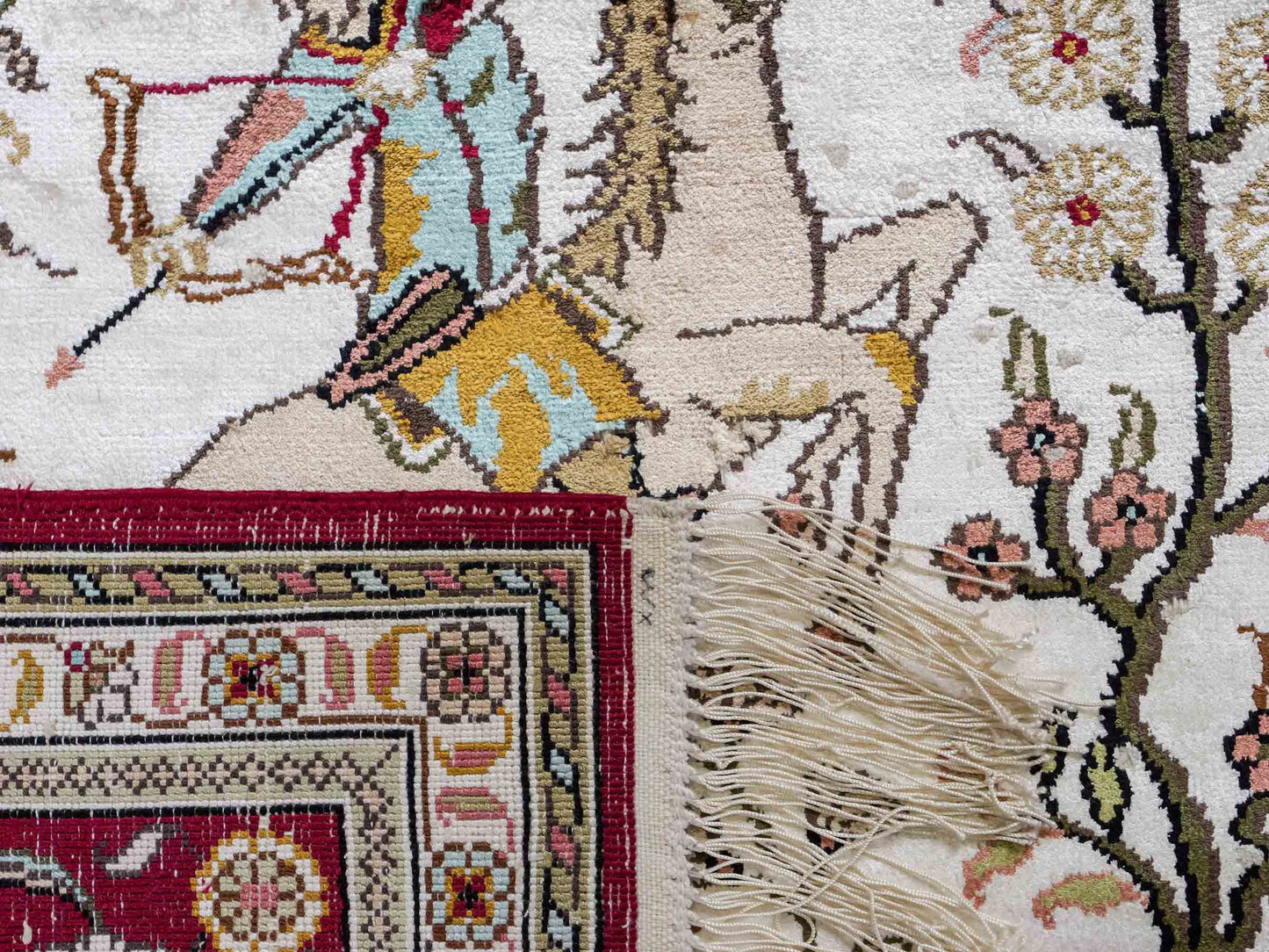 Feiner, handgeknüpfter Art Ghom aus Kunstseide. Ursprung China. Größe: 185 x 124 cm. Hauptfarben: Weiß, Creme, Rot. Vertrieb durch JUPITER Intl.
