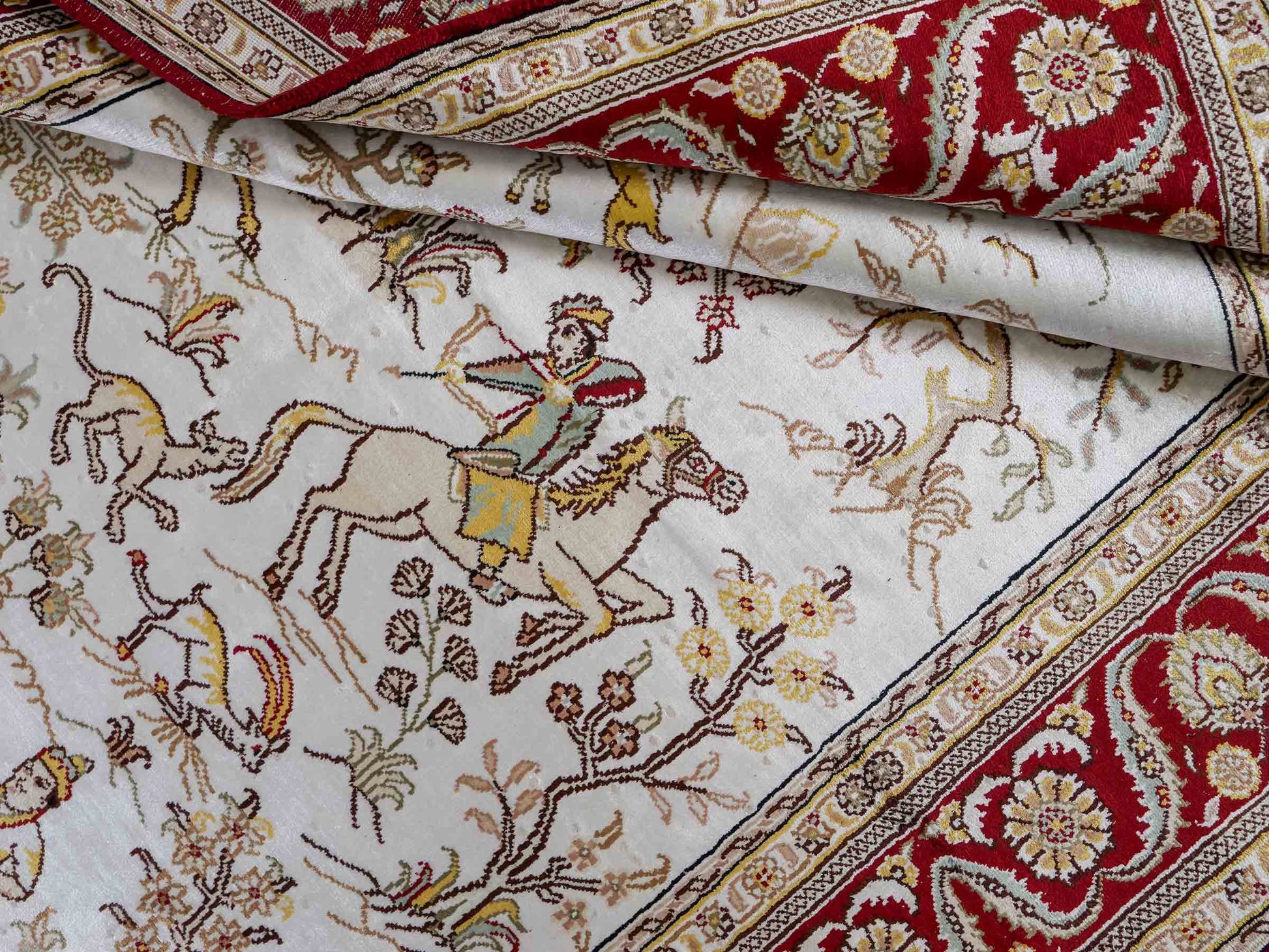 Feiner, handgeknüpfter Art Ghom aus Kunstseide. Ursprung China. Größe: 185 x 127 cm. Hauptfarben: Weiß, Creme, Rot. Vertrieb durch JUPITER Intl.