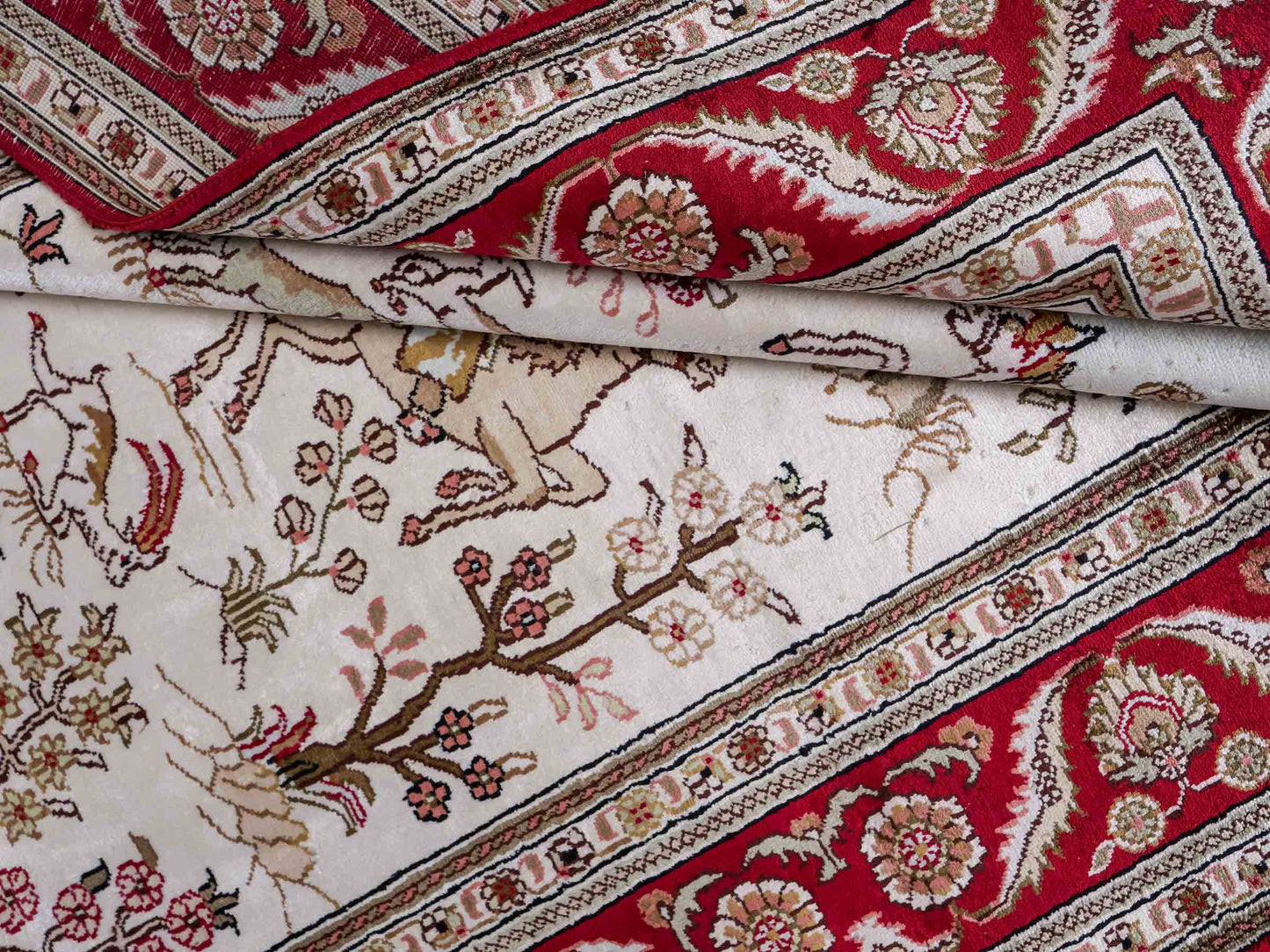 Feiner, handgeknüpfter Art Ghom aus Kunstseide. Ursprung China. Größe: 186 x 124 cm. Hauptfarben: Weiß, Creme, Rot. Vertrieb durch JUPITER Intl.