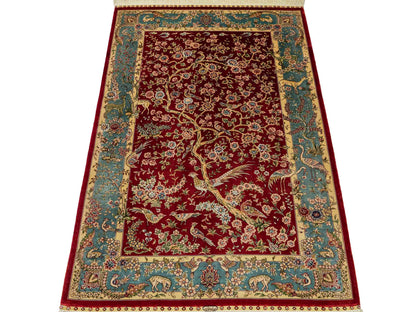 Sehr feiner, handgeknüpfter Khademi Orientteppich mit Ghom Design aus reiner Seide, rot, blau, creme. 124x79 cm. Vertrieb durch Jupiter Intl.