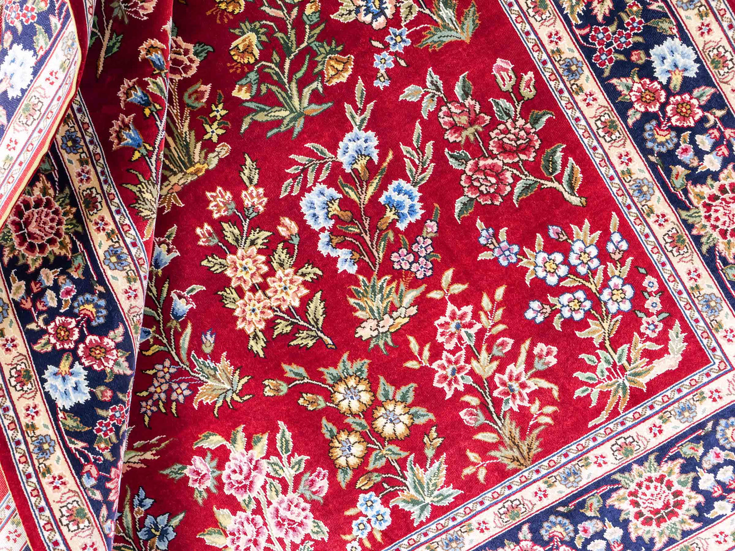 Sehr feiner, handgeknüpfter Khademi Orientteppich mit Ghom Design aus reiner Seide, rot, blau. 143x94 cm. Vertrieb durch Jupiter Intl.