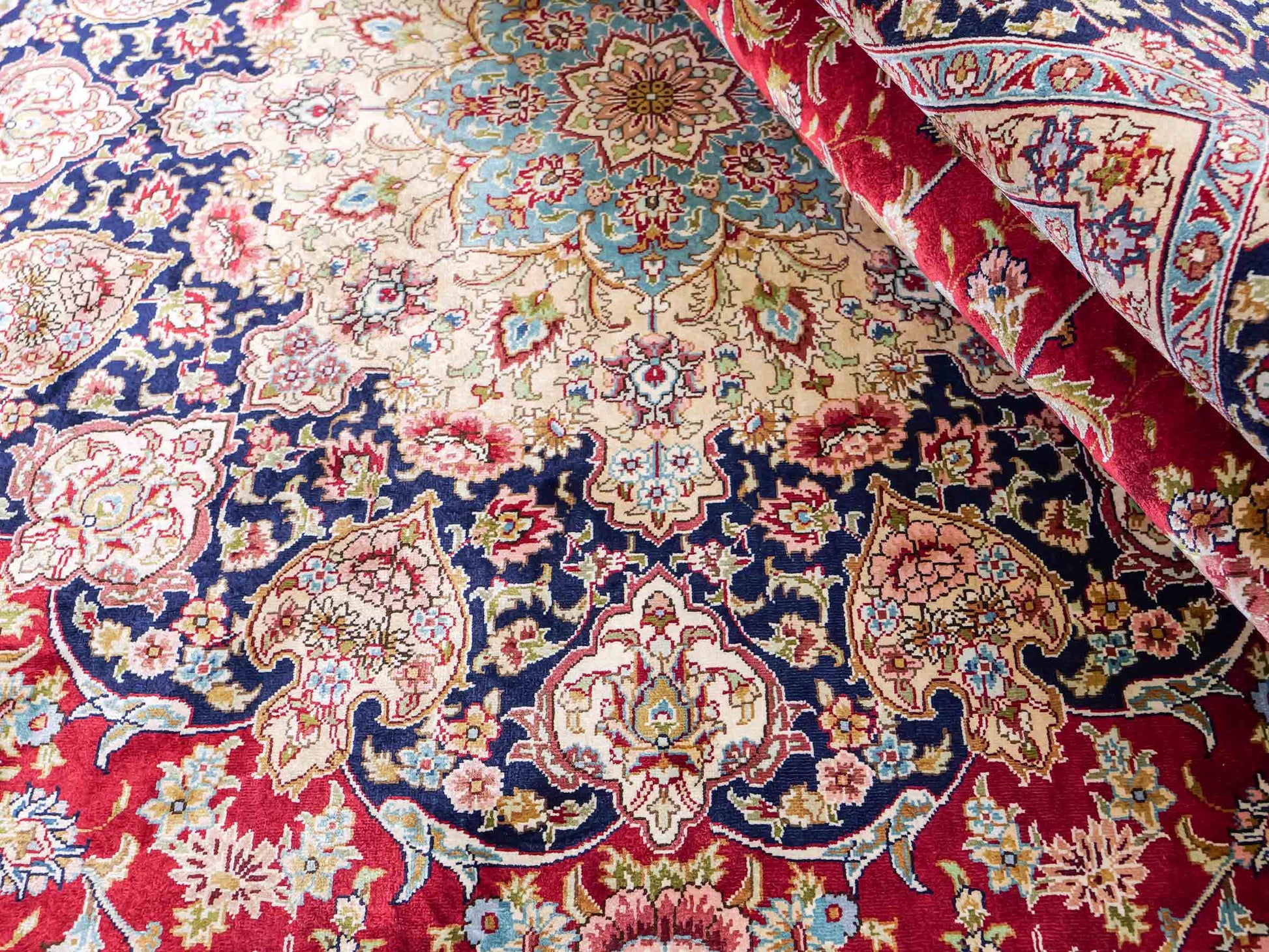 Sehr feiner, handgeknüpfter Khademi Orientteppich mit Ghom Design aus reiner Seide, rot, blau, creme. 278x186 cm. Vertrieb durch Jupiter Intl.
